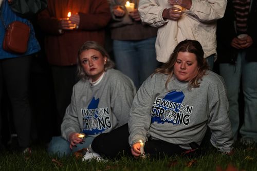 People gather at a vigil for the victims of Wednesday's mass shootings, Sunday, Oct. 29, 2023, outside the Basilica of Saints Peter and Paul in Lewiston, Maine. 