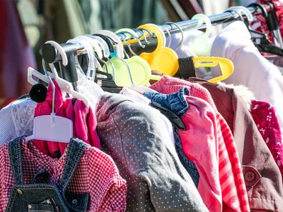 A rack full of second-hand children's clothing