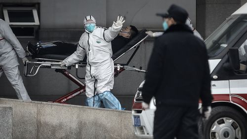 Medical staff transfer patients to Jin Yintan hospital in Wuhan, Hubei, China. Local authorities have confirmed that a third person has died of a pneumonia-like virus since the outbreak started in December.