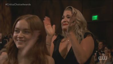 Brendan Fraser's partner Jeanne Moore claps him on during his acceptance speech after winning Best Actor at the Critics' Choice Awards 2023.