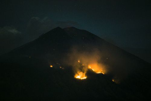 Bali's Mount Agung has erupted sending plumes of ash into the sky, spewing lava two-kilometres away. (AAP)
