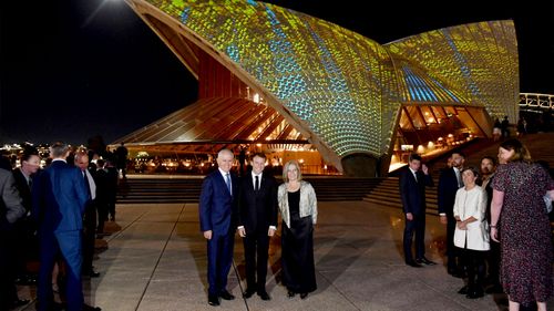French President Emmanuel Macron (centre) poses with Prime Minister Malcolm Turnbull and his wife Lucy outside the Sydney Opera House. (AAP)