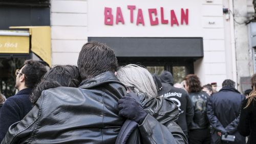 Mourners gather outside the Bataclan concert hall in Paris on the anniversary of the terrorist attack.