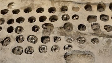 This undated photo provided Wednesday, Aug. 26, 2020, by Osaka City Cultural Properties Association shows human bones buried in holes at the south section of the &quot;Umeda Grave&quot; burial site, in Osaka, western Japan. 