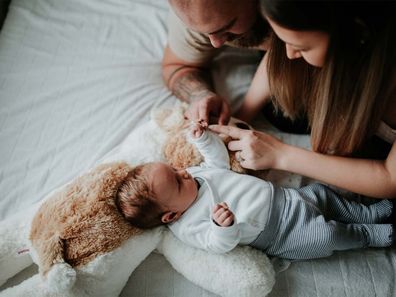 New parents doting over new baby.