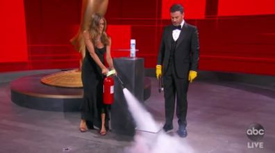 Jimmy Kimmel and Jennifer Aniston sanitise Emmys envelope.