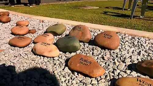 The monument, located at the Brisbane Dog Squad HQ at Oxley in Brisbane's southwest was surrounded by over a dozen named stones representing past service dogs. 