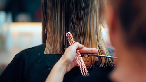 Professional beauty salon worker executing perfect ends trimming