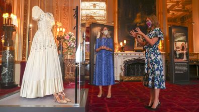 Princess Beatrice poses alongside her wedding dress as it goes on display at Windsor Castle on September 23, 2020 in Windsor, England