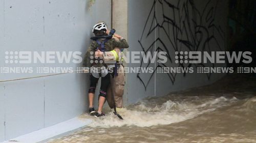 A firefighter rescuing a girl from an aqueduct in Melbourne's south-east.