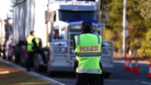Queensland Police stop trucks at the Queensland border in Coolangatta.