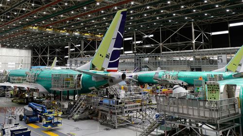 A Boeing 737 MAX 8 airplane is shown on the assembly line.
