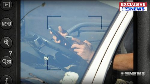 A truck driver has been caught using not one but two mobile phones while driving on Sydney's M5.