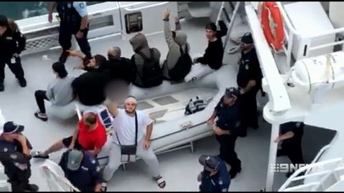 A number of the men and teenagers shouted obscenities at reporters after being taken off the ship. (Supplied)