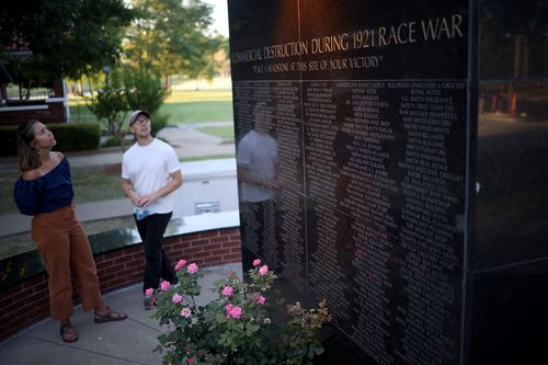 A couple visits the memorial to the Black Wall Street Massacre in Tulsa, Oklahoma. The Black Wall Street Massacre was one of the worst race riots in the history of the United States where more than 35 square blocks of a predominantly black neighbourhood were destroyed in two days of rioting