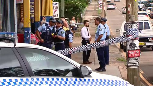 Police attend the scene outside the Campsie business.