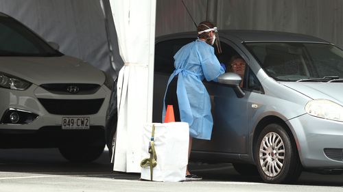 GOLD COAST, AUSTRALIA - JANUARY 05: People are tested for Covid-19 at Southport on January 05, 2022 in Gold Coast, Australia. Queensland is experiencing record-high COVID-19 cases for the state, creating challenges for testing clinics. (Photo by Chris Hyde/Getty Images)