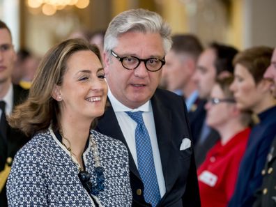 Belgium's Prince Laurent, center, and his wife Claire, left, arrive for a tribute ceremony at the Royal Palace in Brussels for the victims of the Brussels attacks on Sunday, May 22, 2016. 
