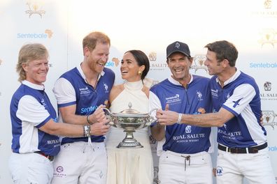 Prince Harry and Meghan Markle, Duchess of Sussex, laugh as she presents him and his polo teammates with the trophy for winning the 2024 Royal Salute Polo Challenge to Benefit Sentebale, Friday, April 12, 2024, in Wellington, Florida