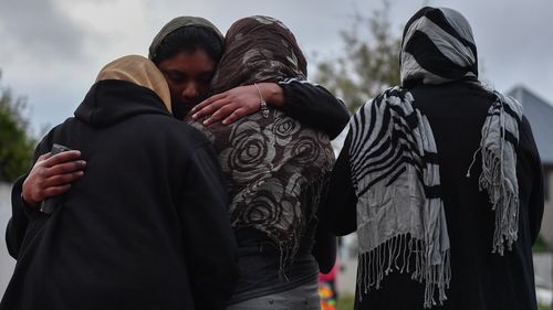 People grieve at a makeshift memorial at the Al Noor Mosque in Christchurch, in the aftermath of the mass shooting.