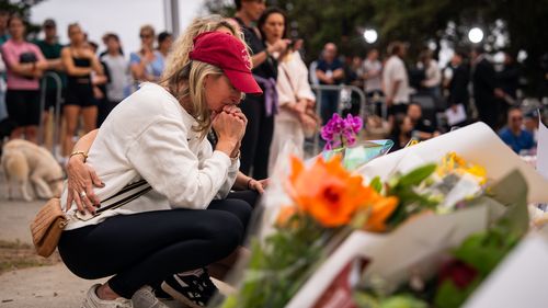 A mourner visits the memorial at Bondi Pavilion, two days after a mass shooting at Bondi Beach, on December 16, 2025 in Sydney, Australia.