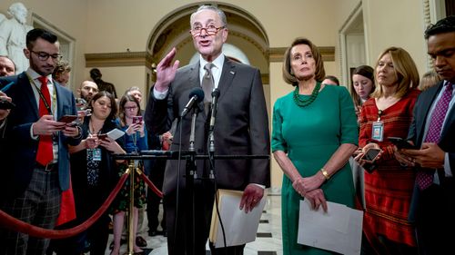 Democratic House Minority Leader Nancy Pelosi and Democratic Senate Minority Leader Chuck Schumer speak to the media as lawmakers prepare to vote on a new budget resolution to avert a government shutdown at the US Capitol in Washington, DC.