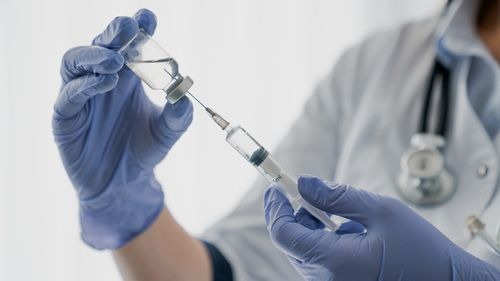 Nurse holding a needle. Injection. Vaccine.