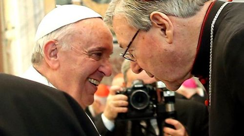 Cardinal Pell sharing a word with Pope Francis. (AAP)