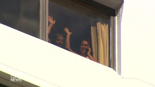 Danny Hodgson's parents Peter and Nicola wave from their Perth hotel room. 