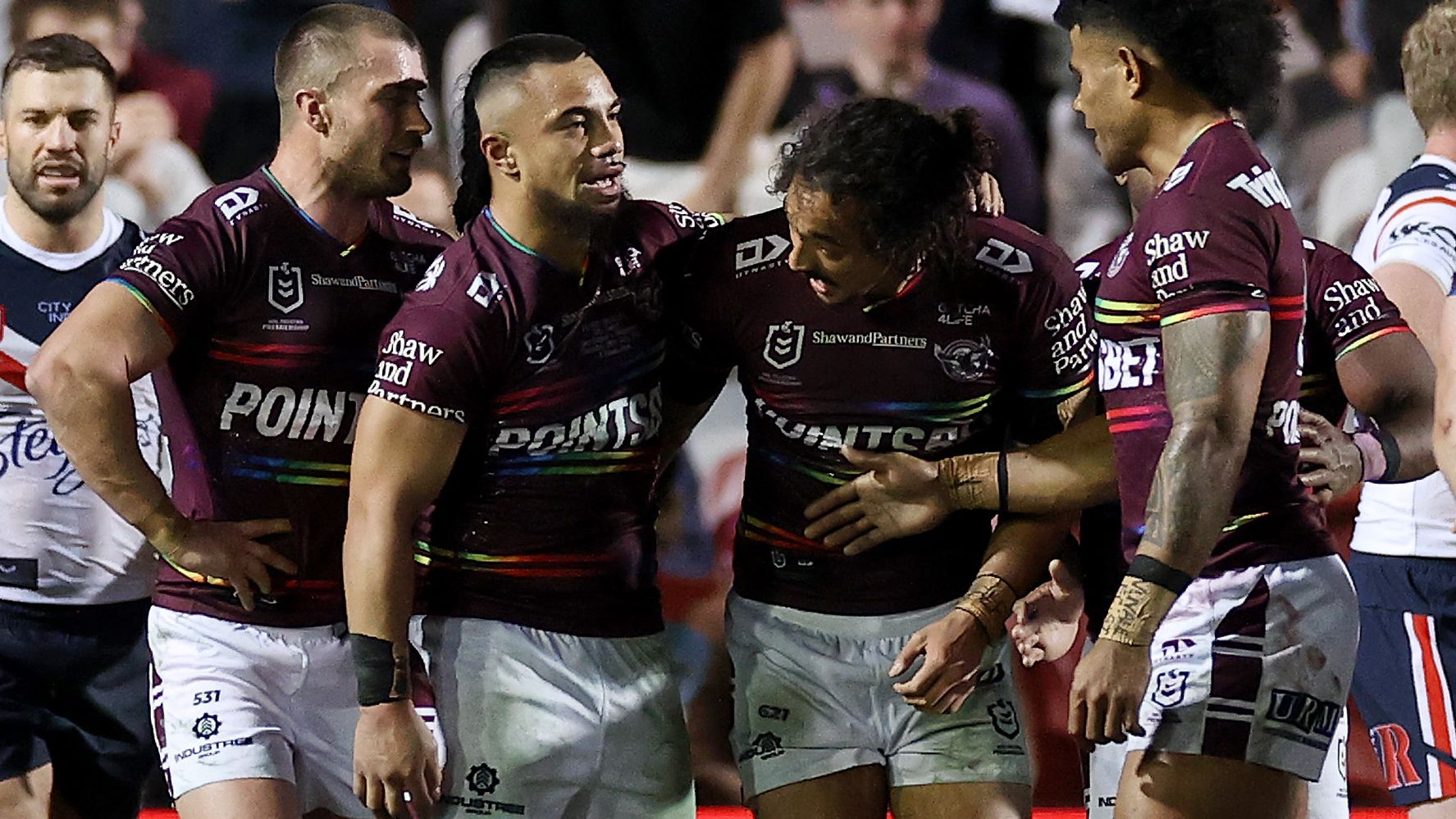 Alfred Smalley of the Sea Eagles celebrates with teammates after scoring a try on debut.