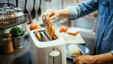 Woman making toast toaster home appliances bread.