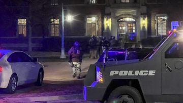 Police investigate the scene of a shooting at Berkey Hall on the campus of Michigan State University.