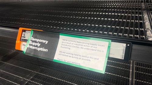 Empty Woolworths shelf after industrial strike impacted supply.