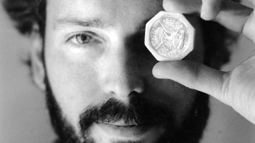 FILE - This November 1989 file photo shows Tommy Thompson holding a $50 pioneer gold piece retrieved earlier in 1989 from the wreck of the gold ship Central America. Thompson, a former deep-sea treasure hunter is about to celebrate his fifth year in jail for refusing to disclose the whereabouts of 500 missing coins made from gold found in an historic ship wreck. Despite an investors lawsuit and a federal court order, Thompson still won't cooperate with authorities trying to find those coins, acc