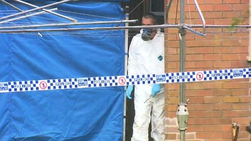 The body was found in an external building at the unit block. (9NEWS)