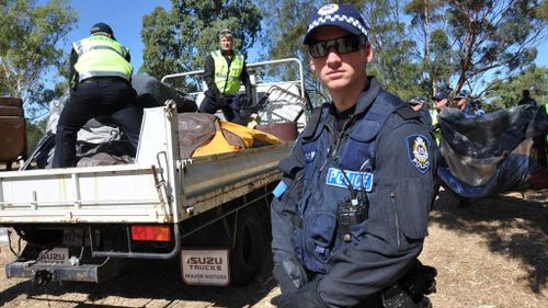 Police remove protester's belongings during a raid at an Aboriginal "tent embassy" in Perth in 2012. (AAP)