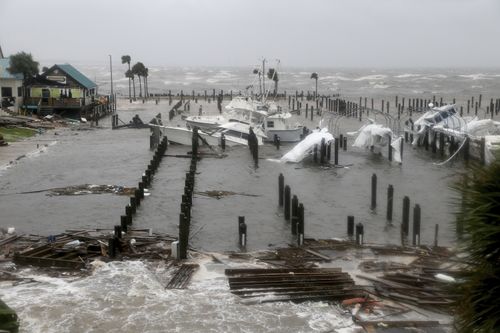 Boats lay sunk and damaged at the Port St. Joe Marina.