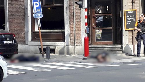 The two police officers lie dead on the ground in Liege. Picture: AP
