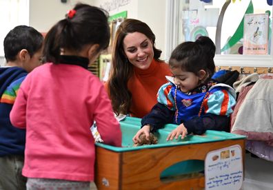 LUTON, ENGLAND - JANUARY 18: Catherine, Princess of Wales interacts with children playing in a sandpit during her visit to Foxcubs Nursery on January 18, 2023 in Luton, England. The Princess of Wales's visit is part of her work highlighting the importance of early childhood development. (Photo by Justin Tallis - WPA Pool/Getty Images)