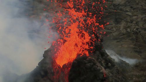 Lava erupts within the summit crater of Kilauea Volcano in Hawaii Volcanoes National Park on Hawaiis Big Island. 