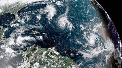 Enhanced satellite image made available by NOAA shows Tropical Storm Florence, center, in the Atlantic Ocean on September 8, 2018. (AAP)