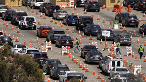 People wait in line for coronavirus testing at Dodger Stadium in Los Angeles.