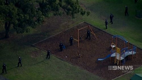 Investigators look for any clues at a nearby park. (9NEWS)