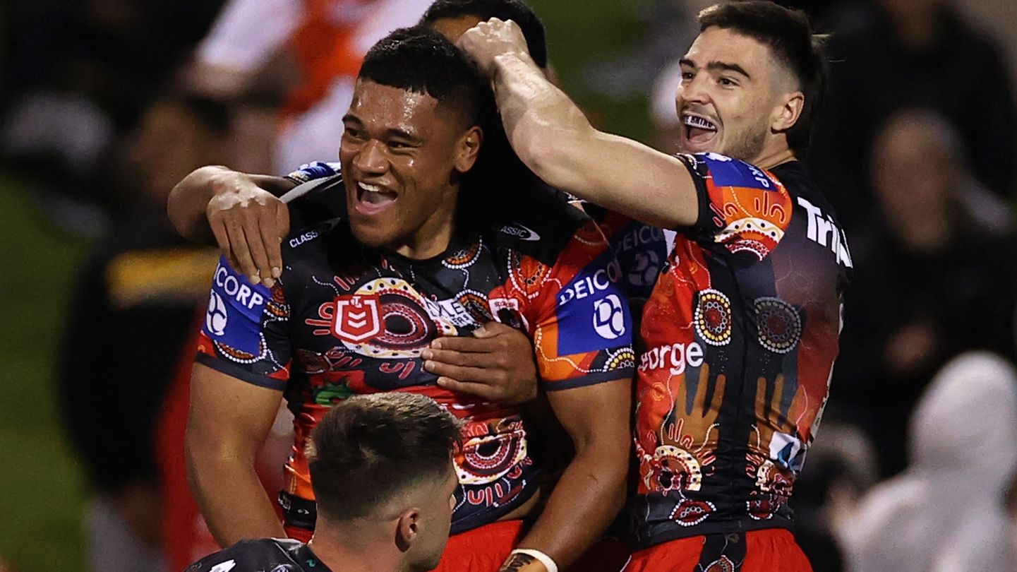 Moses Suli of the Dragons celebrates scoring a try.