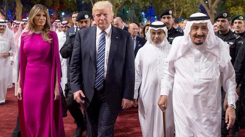 Next Mrs Trump chose to wear a deep magenta dress. (AAP)