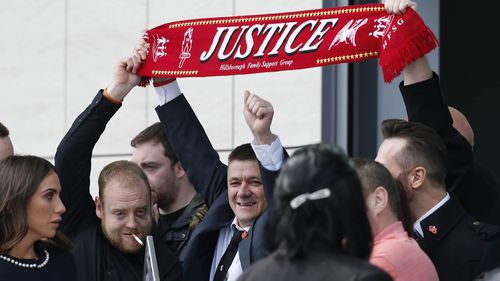 Relatives of the victims who died in the Hillsborough disaster celebrate outside the inquest. (AAP) 