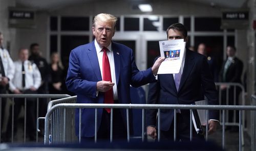 Former President Donald Trump, with attorney Todd Blanche, right, arrives at Manhattan criminal court in New York, on Friday, May 10, 2024. 