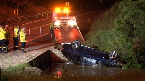 Two charged after car driven into creek following alleged high-speed chase in Sydney's west