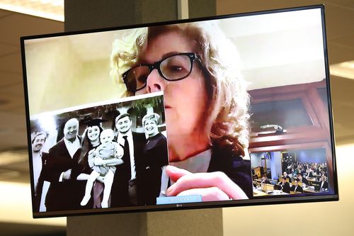 Gillian Millane holds a family photograph during her televised victim impact statement from her home in the UK. The 28-year-old man was found guilty of the murder of British backpacker Grace Millane, whose body was found in bush in West Auckland's Waitakere Ranges on 9 December 2018. Jurors at Auckland's High Court took about four hours to convict him in November 2019