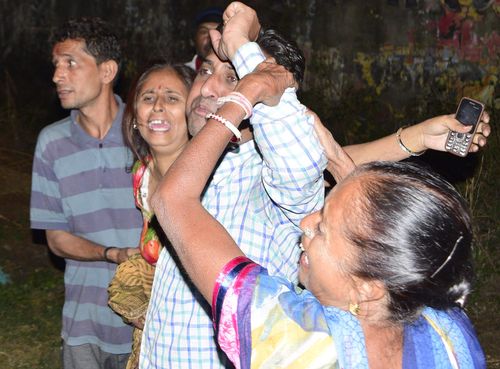 Relatives of the deceased at the scene of the crash. 